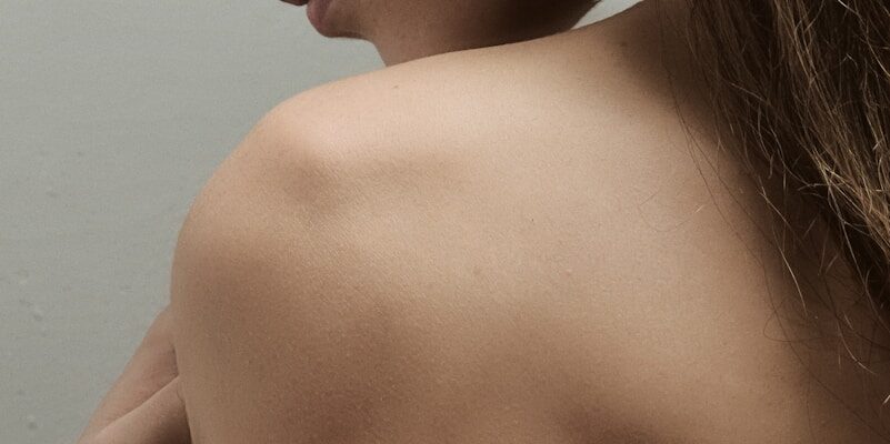 a woman with her arm around her shoulder